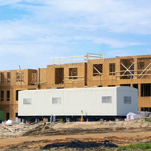 construction site office trailers can be delivered and set up on-site using various methods, including crane placement or truck towing
